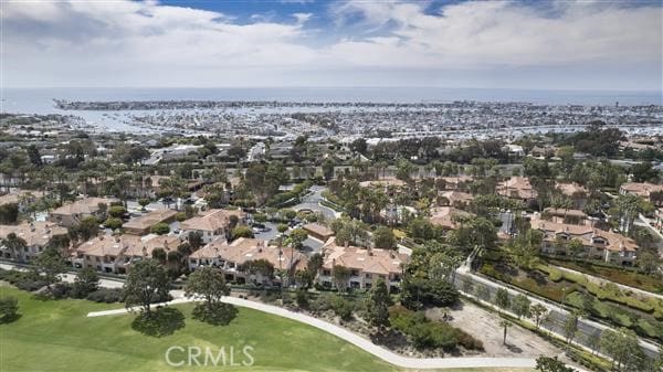 drone / aerial view featuring view of golf course and a residential view