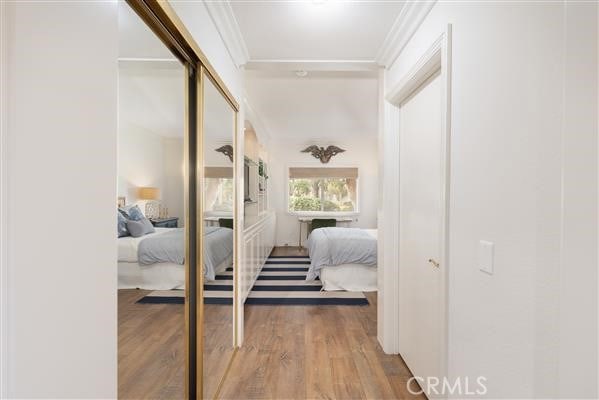 hall with crown molding and wood finished floors