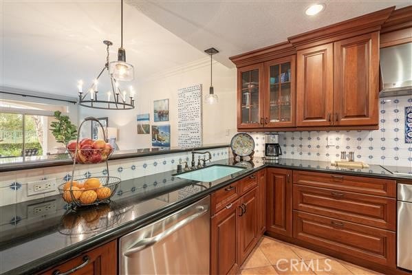 kitchen featuring dark stone countertops, dishwasher, a sink, brown cabinets, and backsplash
