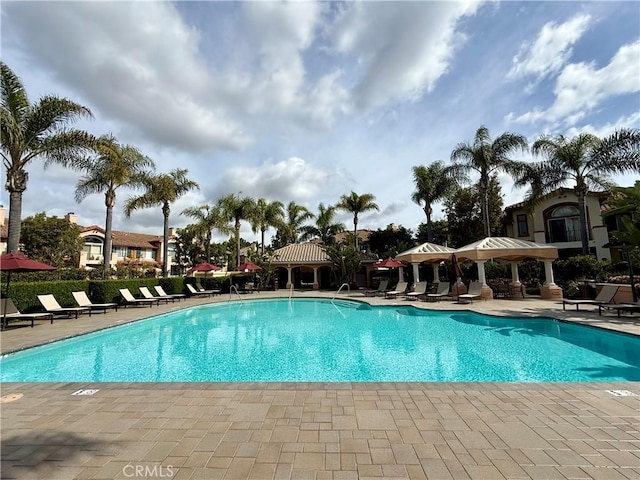 pool with a gazebo and a patio