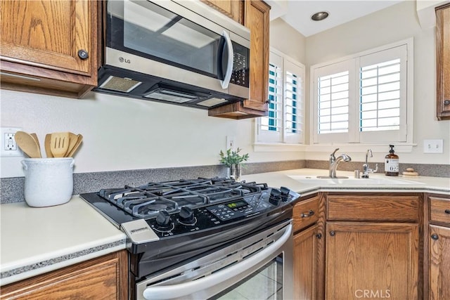 6441 Fiddleneck Ln Unit 23, Avila Beach, CA 93424 - kitchen featuring stainless steel appliances, brown cabinetry, a sink, and light countertops
