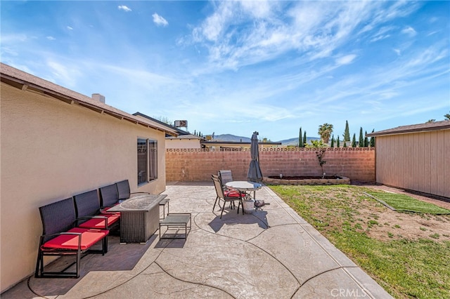 view of patio / terrace featuring outdoor lounge area and fence