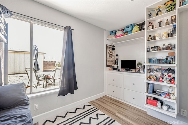 interior space with light wood-type flooring and baseboards
