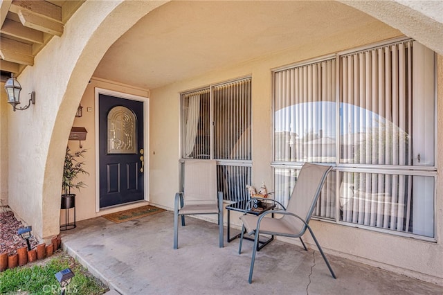 entrance to property featuring stucco siding