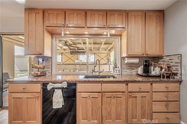 kitchen with stone counters, tasteful backsplash, a sink, and black dishwasher