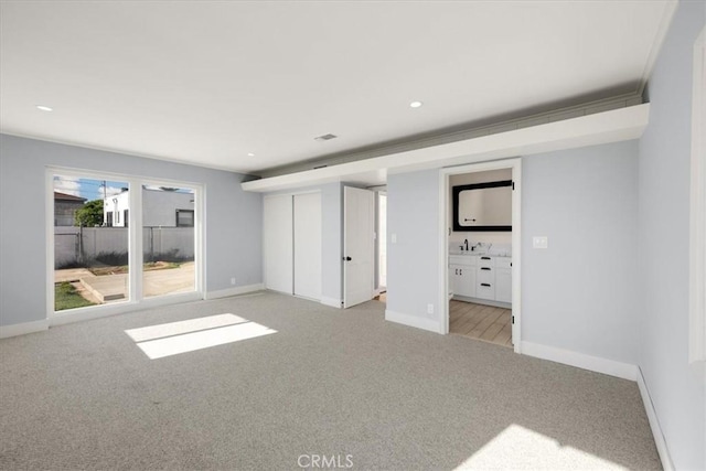 8620 S 4th Ave, Inglewood, CA 90305 - unfurnished bedroom with light carpet, baseboards, ensuite bath, and recessed lighting