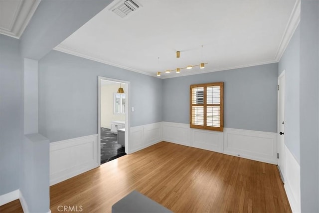 8620 S 4th Ave, Inglewood, CA 90305 - spare room with wood finished floors, wainscoting, and ornamental molding