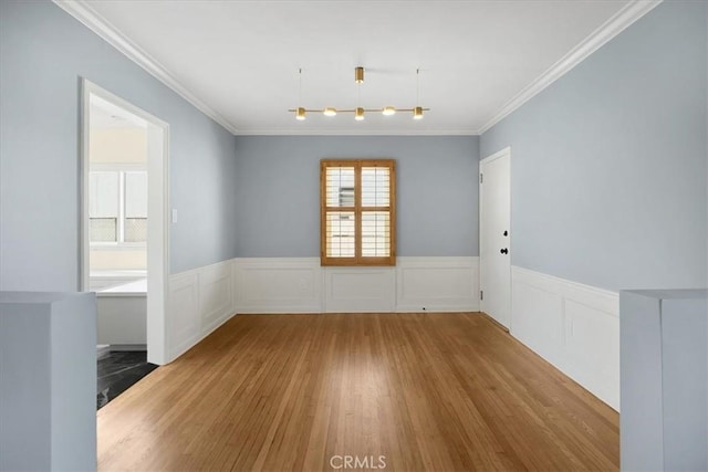 8620 S 4th Ave, Inglewood, CA 90305 - spare room featuring wood finished floors, wainscoting, and ornamental molding