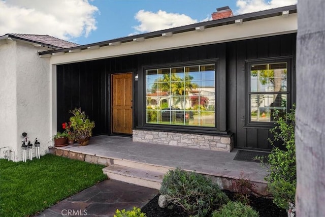 8620 S 4th Ave, Inglewood, CA 90305 - view of exterior entry featuring a chimney, covered porch, and stucco siding