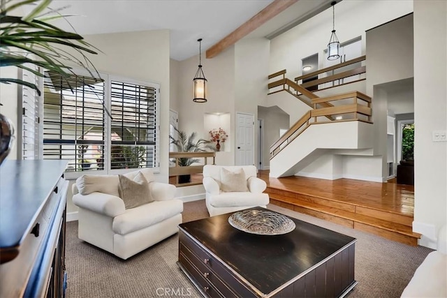 living room with baseboards, beam ceiling, carpet floors, stairs, and high vaulted ceiling