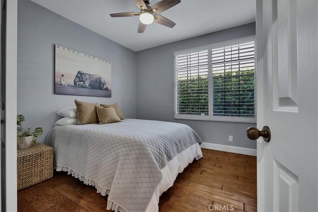 bedroom with baseboards, ceiling fan, and hardwood / wood-style flooring