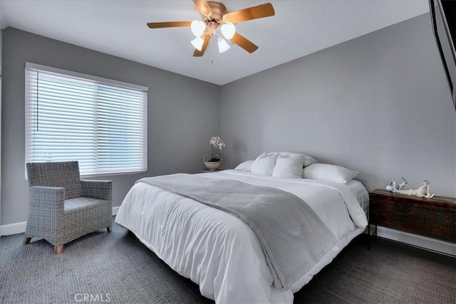 bedroom featuring ceiling fan, baseboards, and carpet floors