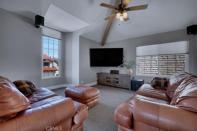 carpeted living area featuring lofted ceiling with beams, ceiling fan, and baseboards