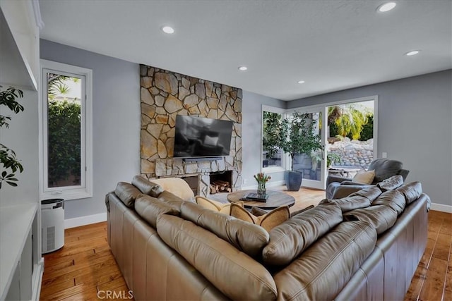 living area with baseboards, recessed lighting, and plenty of natural light