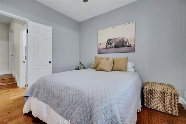 bedroom with ceiling fan and wood finished floors