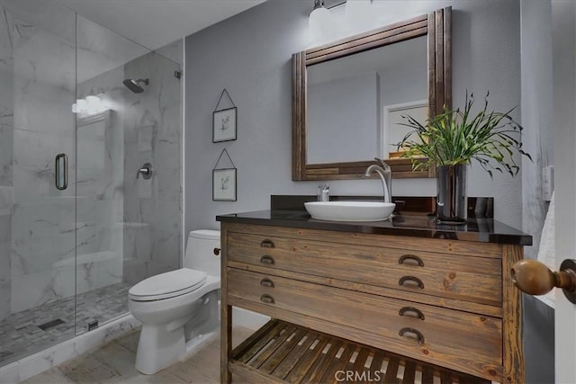 full bath featuring a marble finish shower, toilet, marble finish floor, and vanity