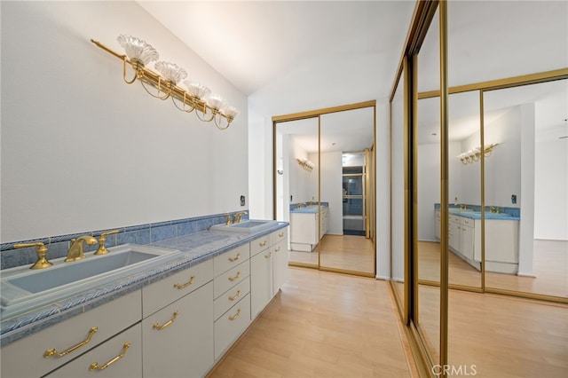 35 Linden Unit 302, Long Beach, CA 90802 - bathroom with double vanity, wood finished floors, and lofted ceiling