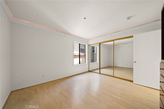 35 Linden Unit 302, Long Beach, CA 90802 - unfurnished bedroom featuring crown molding, wood finished floors, a closet, and baseboards
