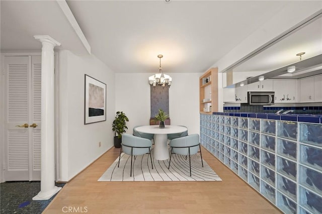 35 Linden Unit 302, Long Beach, CA 90802 - dining area featuring ornate columns, wood finished floors, and a chandelier