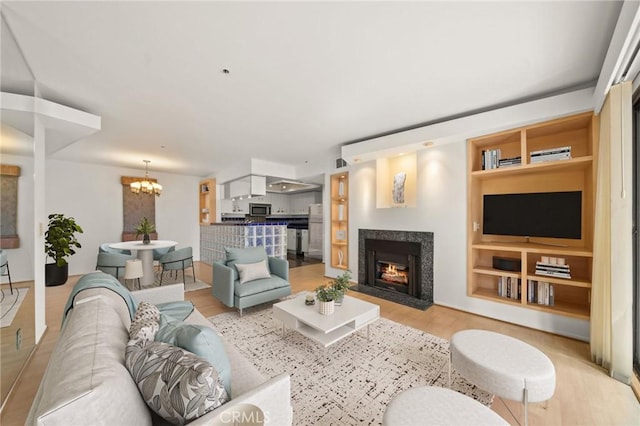 35 Linden Unit 302, Long Beach, CA 90802 - living room featuring a chandelier, a premium fireplace, wood finished floors, and built in features