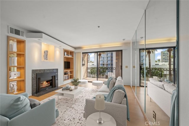 35 Linden Unit 302, Long Beach, CA 90802 - living room featuring built in features, a fireplace, plenty of natural light, and wood finished floors