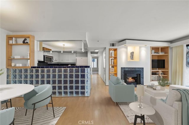 35 Linden Unit 302, Long Beach, CA 90802 - living area with light wood finished floors and a warm lit fireplace