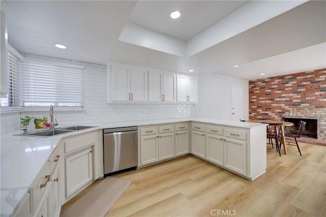 4210 Sirius Ave, Lompoc, CA 93436 - kitchen featuring a peninsula, light countertops, light wood-style floors, stainless steel dishwasher, and a sink