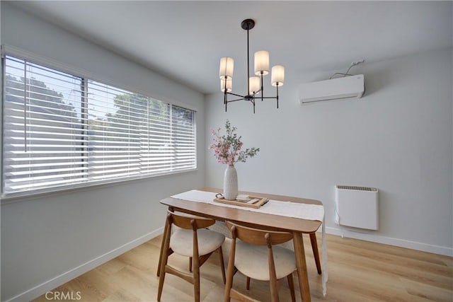 4210 Sirius Ave, Lompoc, CA 93436 - dining room with a wall mounted AC, light wood finished floors, a notable chandelier, and baseboards