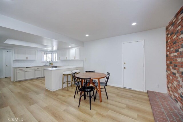 4210 Sirius Ave, Lompoc, CA 93436 - dining space with light wood-style flooring, recessed lighting, and brick wall