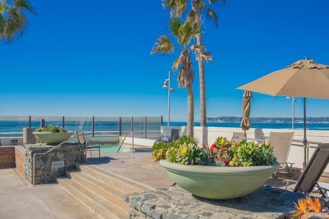view of patio with a water view