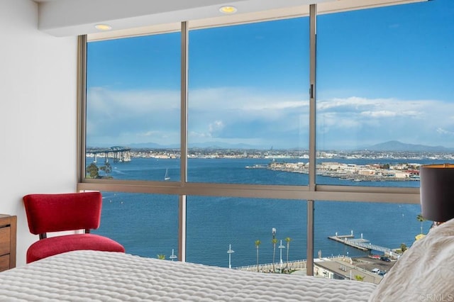 bedroom featuring a water and mountain view