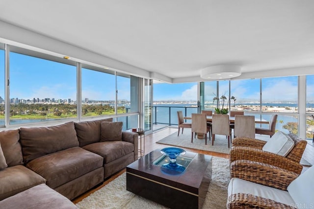 sunroom / solarium featuring a view of city and a water view