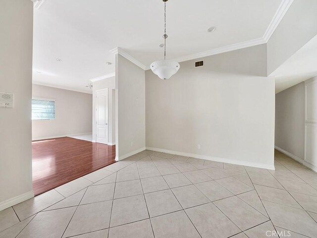 8309 Hillside Rd, Alta Loma, CA 91701 - empty room featuring crown molding, light tile patterned floors, and baseboards