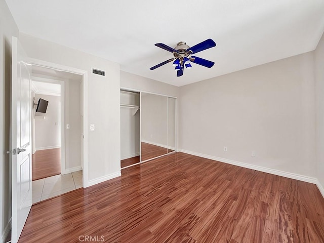 8309 Hillside Rd, Alta Loma, CA 91701 - unfurnished bedroom featuring wood finished floors, a closet, baseboards, and a ceiling fan
