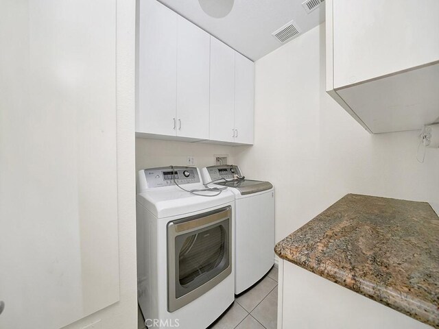 8309 Hillside Rd, Alta Loma, CA 91701 - clothes washing area featuring cabinet space, washing machine and clothes dryer, and light tile patterned floors
