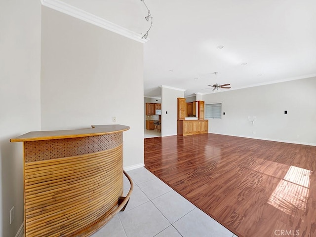 8309 Hillside Rd, Alta Loma, CA 91701 - unfurnished living room featuring a ceiling fan, crown molding, light tile patterned floors, and baseboards
