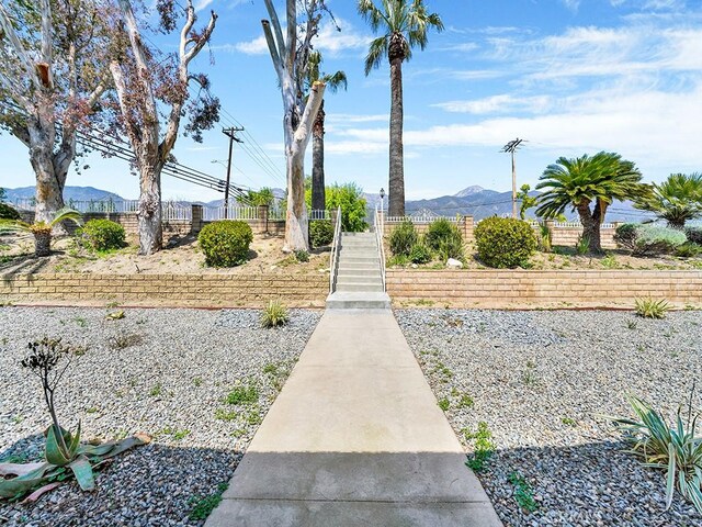 8309 Hillside Rd, Alta Loma, CA 91701 - view of property's community featuring a mountain view, fence, and stairway