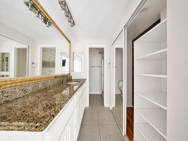 8309 Hillside Rd, Alta Loma, CA 91701 - full bath with tile patterned floors, vanity, toilet, baseboards, and a closet
