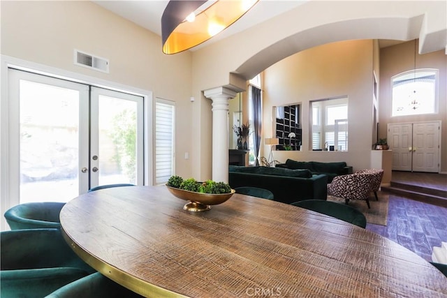 26962 Willow Tree Ln, Laguna Hills, CA 92653 - dining space featuring french doors, arched walkways, decorative columns, visible vents, and wood finished floors