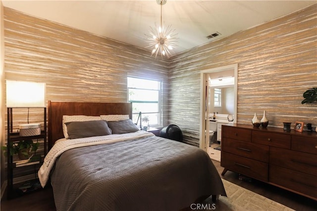 26962 Willow Tree Ln, Laguna Hills, CA 92653 - bedroom with wood finished floors, ensuite bath, visible vents, and a notable chandelier
