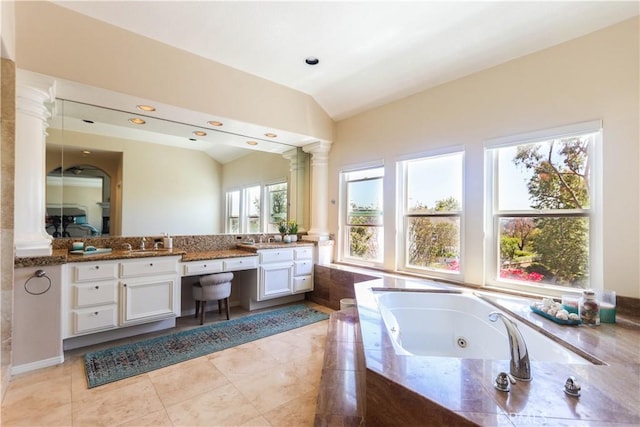 26962 Willow Tree Ln, Laguna Hills, CA 92653 - bathroom with ornate columns, double vanity, vaulted ceiling, a tub with jets, and a sink
