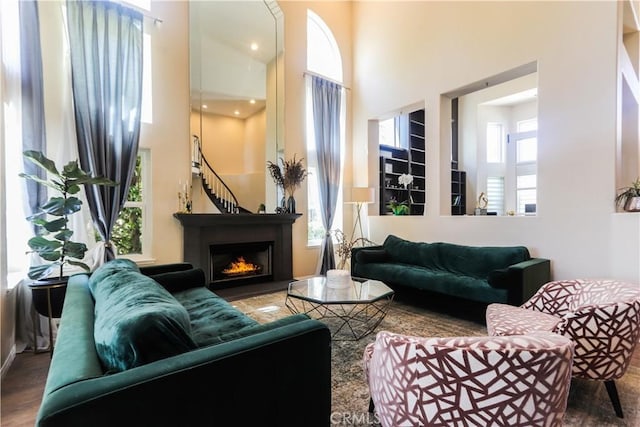 26962 Willow Tree Ln, Laguna Hills, CA 92653 - living area with a warm lit fireplace, wood finished floors, and a towering ceiling