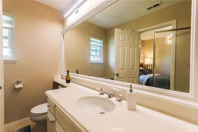 26962 Willow Tree Ln, Laguna Hills, CA 92653 - bathroom with visible vents, toilet, vanity, connected bathroom, and baseboards