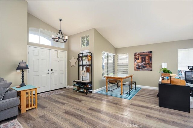 23898 Via Pamilla, Murrieta, CA 92562 - foyer entrance featuring a chandelier, wood finished floors, healthy amount of natural light, and high vaulted ceiling