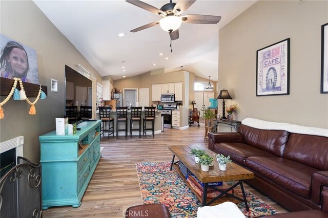 23898 Via Pamilla, Murrieta, CA 92562 - living room with ceiling fan, light wood finished floors, vaulted ceiling, recessed lighting, and baseboards