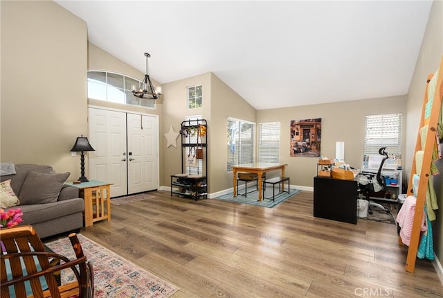 23898 Via Pamilla, Murrieta, CA 92562 - living area featuring wood finished floors, a chandelier, high vaulted ceiling, and baseboards