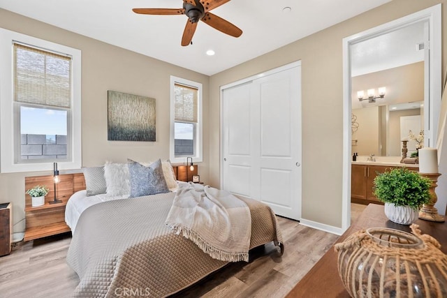 7 Alienta Ln, Rancho Mission Viejo, CA 92694 - bedroom with a closet, baseboards, ensuite bathroom, light wood-type flooring, and a sink