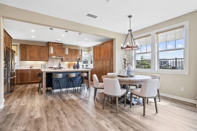 7 Alienta Ln, Rancho Mission Viejo, CA 92694 - dining space featuring visible vents, baseboards, recessed lighting, light wood finished floors, and a notable chandelier