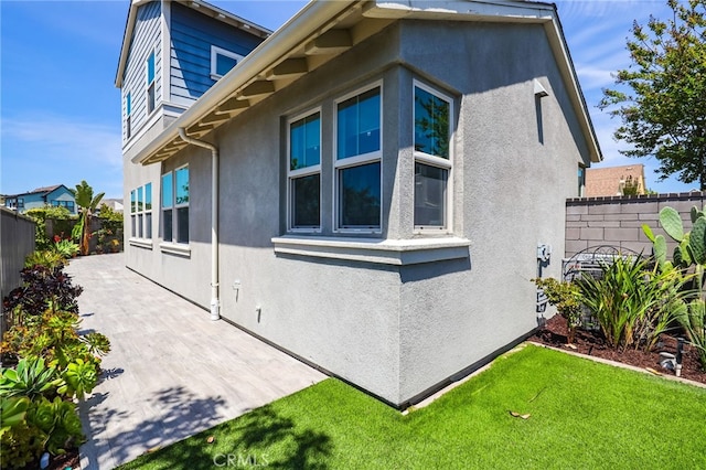 7 Alienta Ln, Rancho Mission Viejo, CA 92694 - view of property exterior with a yard, fence, a patio area, and stucco siding
