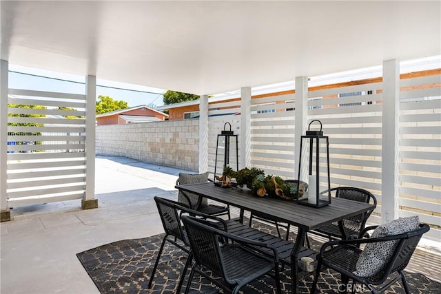 view of patio featuring fence and outdoor dining area